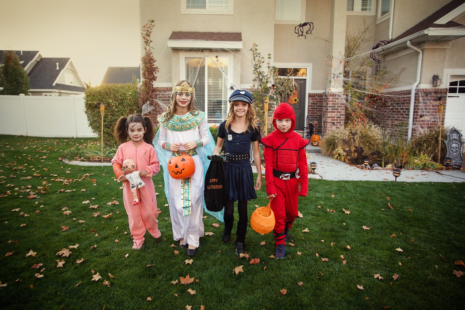 Children in Halloween costumes trick-or-treating in a neighborhood